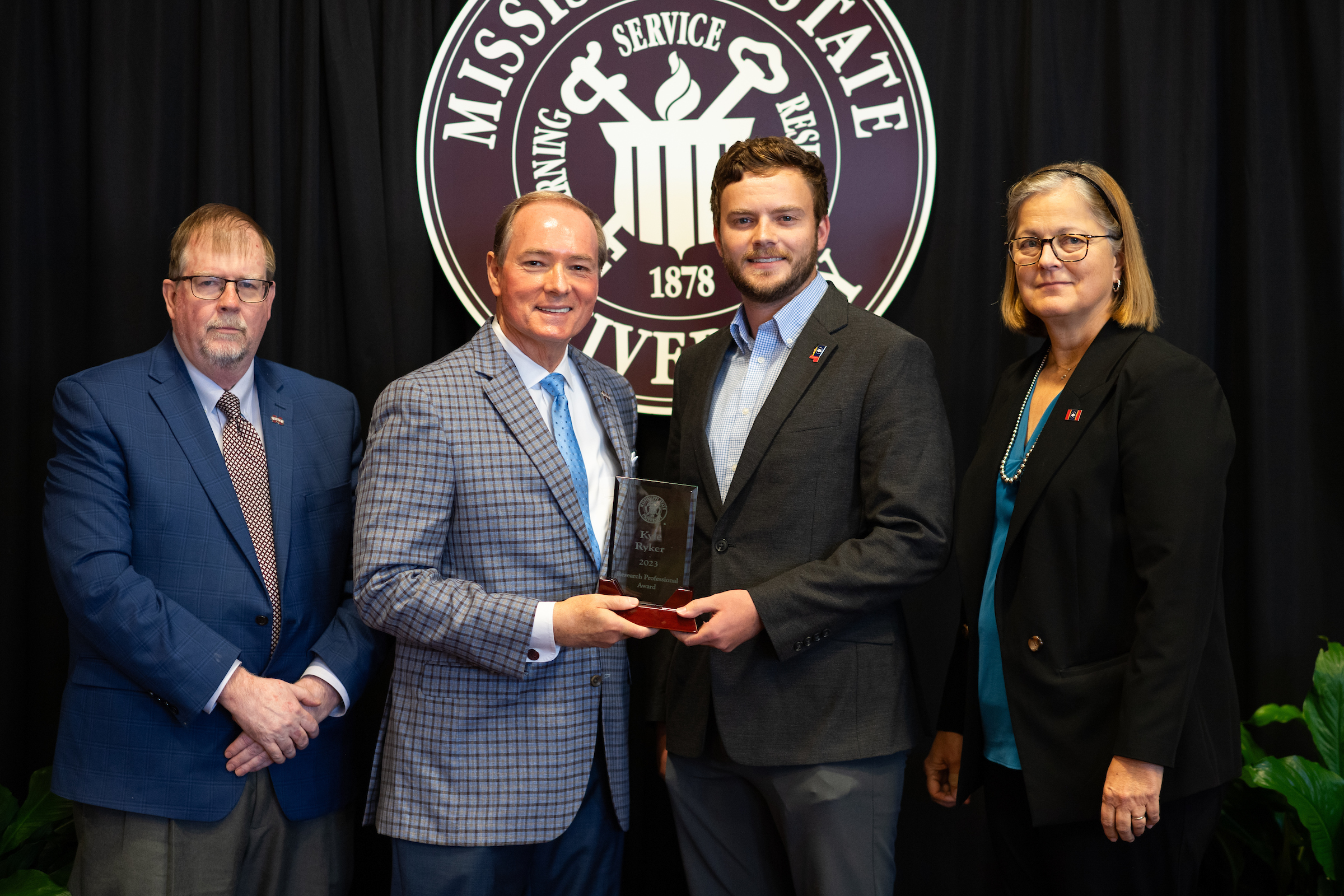 Kyle Ryker with President Keenum receiving Research Professional award