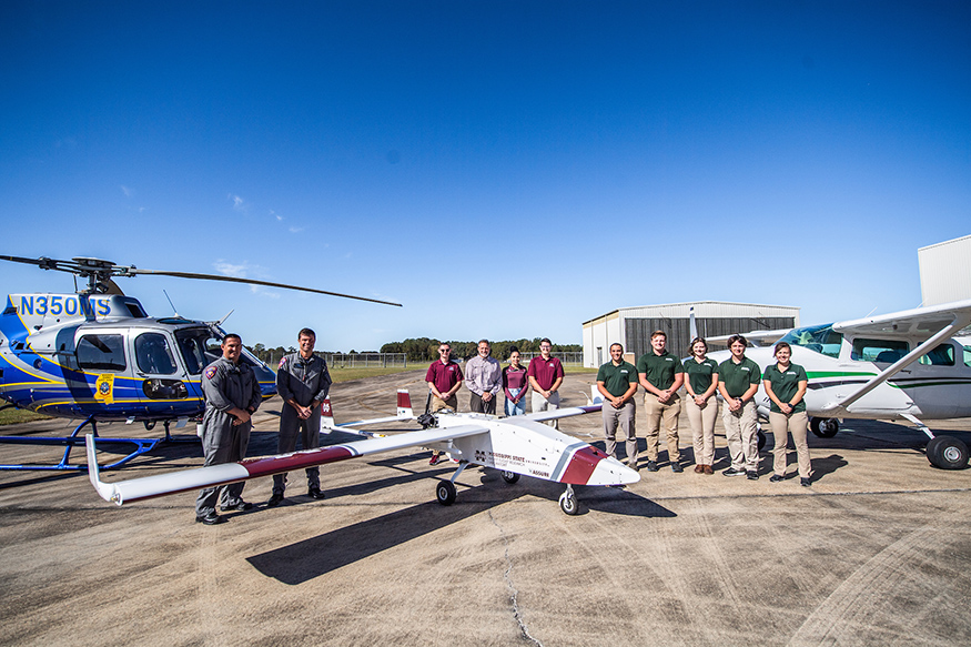 MHP, MSU, and DSU employees post with aircraft